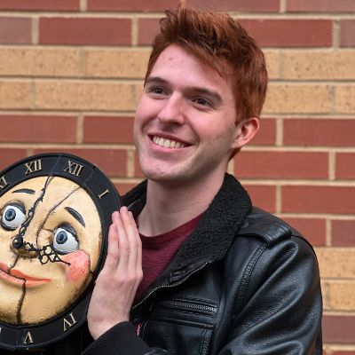 Picture of Olly Glenn holding a model of the clock creature from Whittled Down